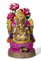 Happy Ganesh Chaturthi Festival - Beautiful Ganesh statue made of clay with flowers on white background. photo