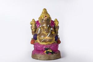 Ganesh idol made of clay on white background. photo