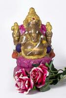 Happy Ganesh Chaturthi Festival - Indian Hindu God Lord Ganesh Statue Made Of Clay with flowers on white background. photo