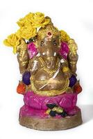 Ganesh Chaturthi - Idol of lord Ganesh with flowers on white background. photo