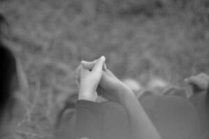 a black and white photo of two people holding hands