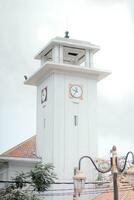 a white building with a clock tower photo