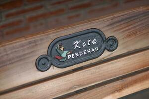 a wooden bench with a sign on it photo