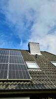 Solar panels producing clean energy on a roof of a residential house video