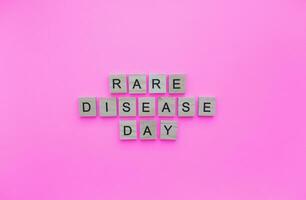 February 28, Rare Disease Day, minimalistic banner with the inscription in wooden letters photo