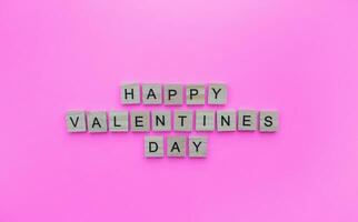 February 14, Valentines Day, minimalistic banner with the inscription in wooden letters photo