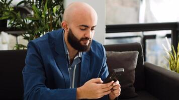Businessman creating startup report on smartphone app, using online analytics and solving development problems in office. Startup consultant thinking about new business plan and solution. photo