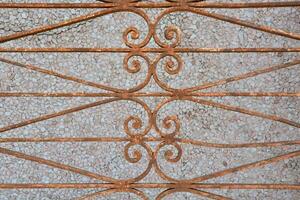 an old iron fence with decorative designs photo