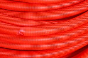 a close up of a red hose with a white background photo