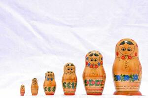 a row of wooden dolls with different faces photo