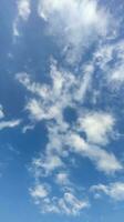 a blue sky with clouds and a few clouds, Blue sky, white cloud time lapse of clouds in the sky, the sun shines through the clouds in this photo, dramatic sky clouds photo