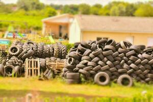 a pile of tires in a field photo