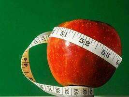 an apple with a measuring tape around it photo