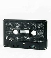 a black and white cassette with a white background photo