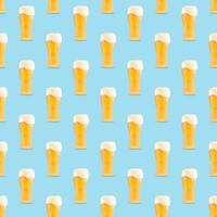 Seamless pattern of large beer glass full of beer with foam on blue background. photo
