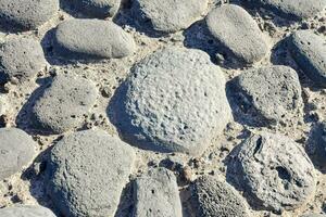 a close up of a stone wall with many different types of rocks photo