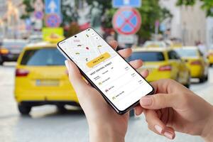 Taxi mobile app with smart maps and order button. Taxi vehicles in the background photo