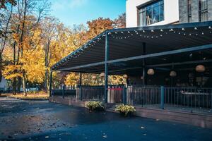 Street view with cafe terrace in the autumn concept photo