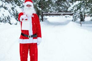 Santa Claus outdoor in winter and snow handing in hand paper bags with craft gift, food delivery. Shopping, packaging recycling, handmade, delivery for Christmas and New year photo