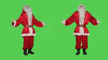 Doubtful saint nick raise shoulders on full body greenscreen, doing i dont know confused gesture feeling uncertain on camera. Santa in costume acting unsure about answer, person shrugging. photo