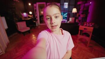 Gen z youngster filming POV style video with phone for online channel, talking with viewers. Kid telling audience topics she wishes to explore in future clips, recording with selfie smartphone camera