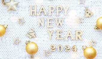 Happy New Year wooden letters and the numbers 2024 on cozy festive white knitted background with sequins, stars, lights of garlands. Greetings, postcard. Calendar, cover photo