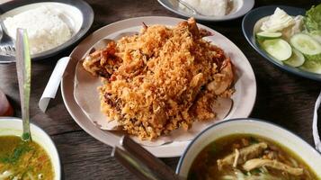 Photo of fried crispy spicy chicken on wooden table