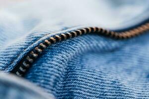 Fashionable blue jeans with metal zip, close-up photo