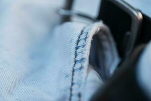 Blue jeans, macro. fashion denim textile and leather belt photo