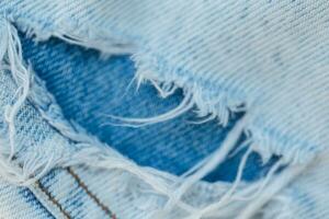 Ripped jeans, close-up. Fashion denim torn pants photo