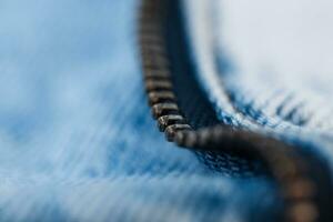 Metal zipper and blue jeans texture, macro. Fashion denim photo