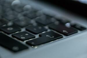 Laptop keyboard with focus on the inter button, close-up. Login and start concept photo