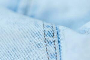 Light blue jeans texture, close-up. Jeans fashion and denim fabric photo