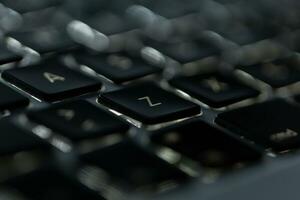 Laptop keyboard with letters, close-up photo