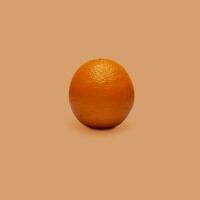 Orange fruit isolated on orange background. The concept of the benefits of citrus fruits. photo