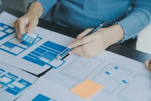 ux Graphic designer creative sketch planning application process development prototype wireframe for web mobile phone . User experience concept. photo