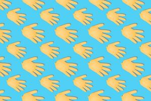 Seamless pattern with inflated yellow medical gloves on bright blue background. Prevention and protection of coronavirus, covid-19. Healthcare concept. Abstract background. photo