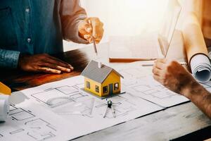 Construction and structure concept of engineer working drawing on blueprint meeting for project working with partner on model building and engineering tools in working site, construction concept. photo