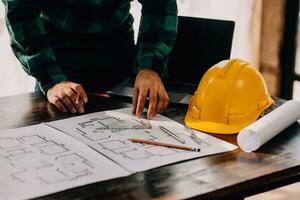 Construction and structure concept of engineer working drawing on blueprint meeting for project working with partner on model building and engineering tools in working site, construction concept. photo
