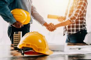 Construction and structure concept of engineer working drawing on blueprint meeting for project working with partner on model building and engineering tools in working site, construction concept. photo