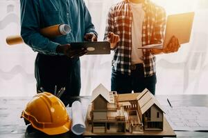 Construction and structure concept of engineer working drawing on blueprint meeting for project working with partner on model building and engineering tools in working site, construction concept. photo