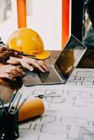 Construction and structure concept of engineer working drawing on blueprint meeting for project working with partner on model building and engineering tools in working site, construction concept. photo