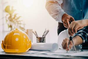 Construction and structure concept of engineer working drawing on blueprint meeting for project working with partner on model building and engineering tools in working site, construction concept. photo