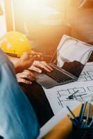 Construction and structure concept of engineer working drawing on blueprint meeting for project working with partner on model building and engineering tools in working site, construction concept. photo