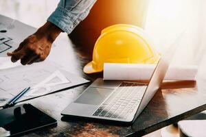 Construction and structure concept of engineer working drawing on blueprint meeting for project working with partner on model building and engineering tools in working site, construction concept. photo