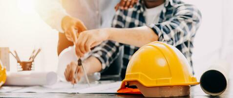 Construction and structure concept of engineer working drawing on blueprint meeting for project working with partner on model building and engineering tools in working site, construction concept. photo