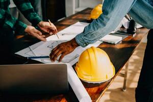 Construction and structure concept of engineer working drawing on blueprint meeting for project working with partner on model building and engineering tools in working site, construction concept. photo