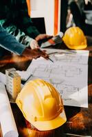Construction and structure concept of engineer working drawing on blueprint meeting for project working with partner on model building and engineering tools in working site, construction concept. photo