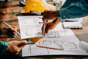 Construction and structure concept of engineer working drawing on blueprint meeting for project working with partner on model building and engineering tools in working site, construction concept. photo