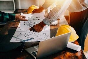 Construction and structure concept of engineer working drawing on blueprint meeting for project working with partner on model building and engineering tools in working site, construction concept. photo